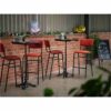 "Bourbon-bar-chairs-in-Tabasco-with-Solid-Wood-Walnut-round-tops-on-Bistro-Poseur-height-bases-2.jpg"